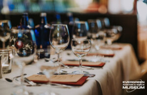 A table is set with menus and empty wine glasses.