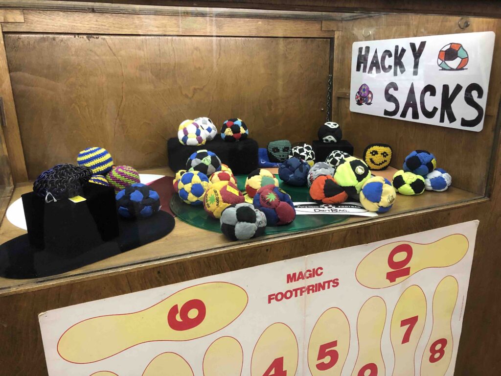 A display case with hacky sacks.
