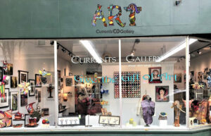 The storefront of Currents Gallery. It's a large window with art displayed.