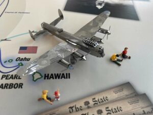 Tiny figurines sit on a map with a tiny Spruce Goose.