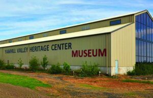 The outside of a large museum. It says Yamhill County Heritage Museum in large letters on the side.