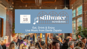 A photo of many people sitting at tables eating. An overlay says Stillwater Sessions.
